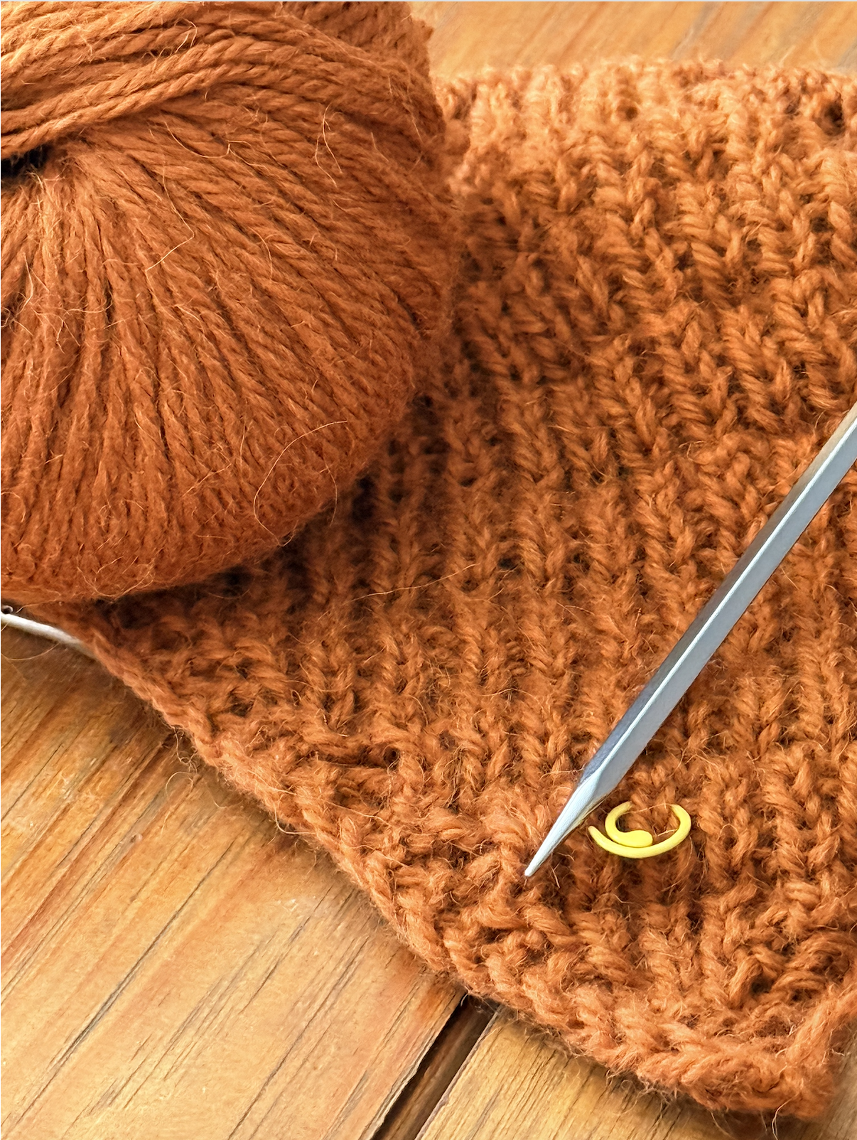 Ember Ridge shawl in progress with yarn and needle