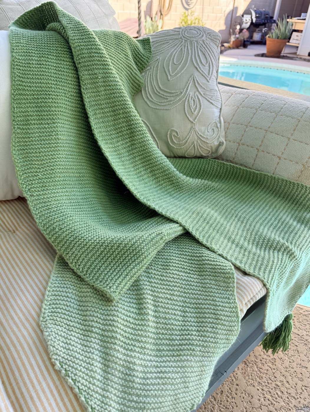 Shades of Nine gradient garter wrap draped over a patio sofa