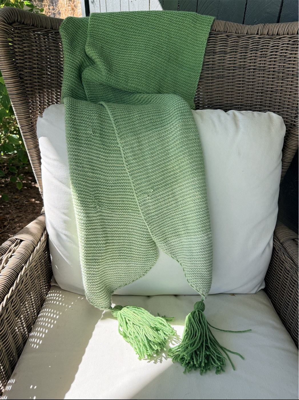 Shades of Nine wrap over a wicker chair, showing both pointed tips and tassels
