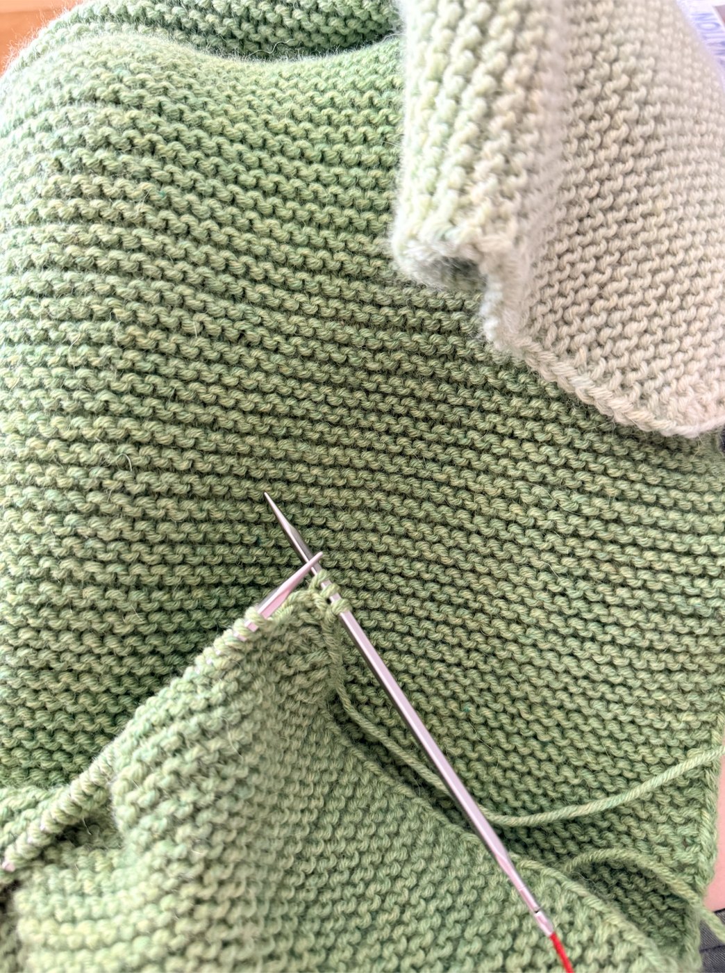 Garter ridges in progress on the needles, showing a color change