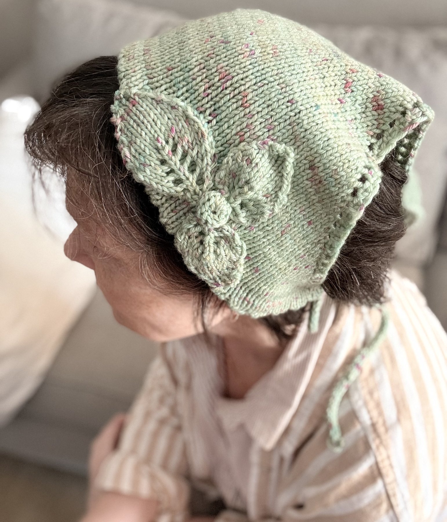 Sweetbriar Bandana worn as a headscarf, showing the knitted flower appliqué