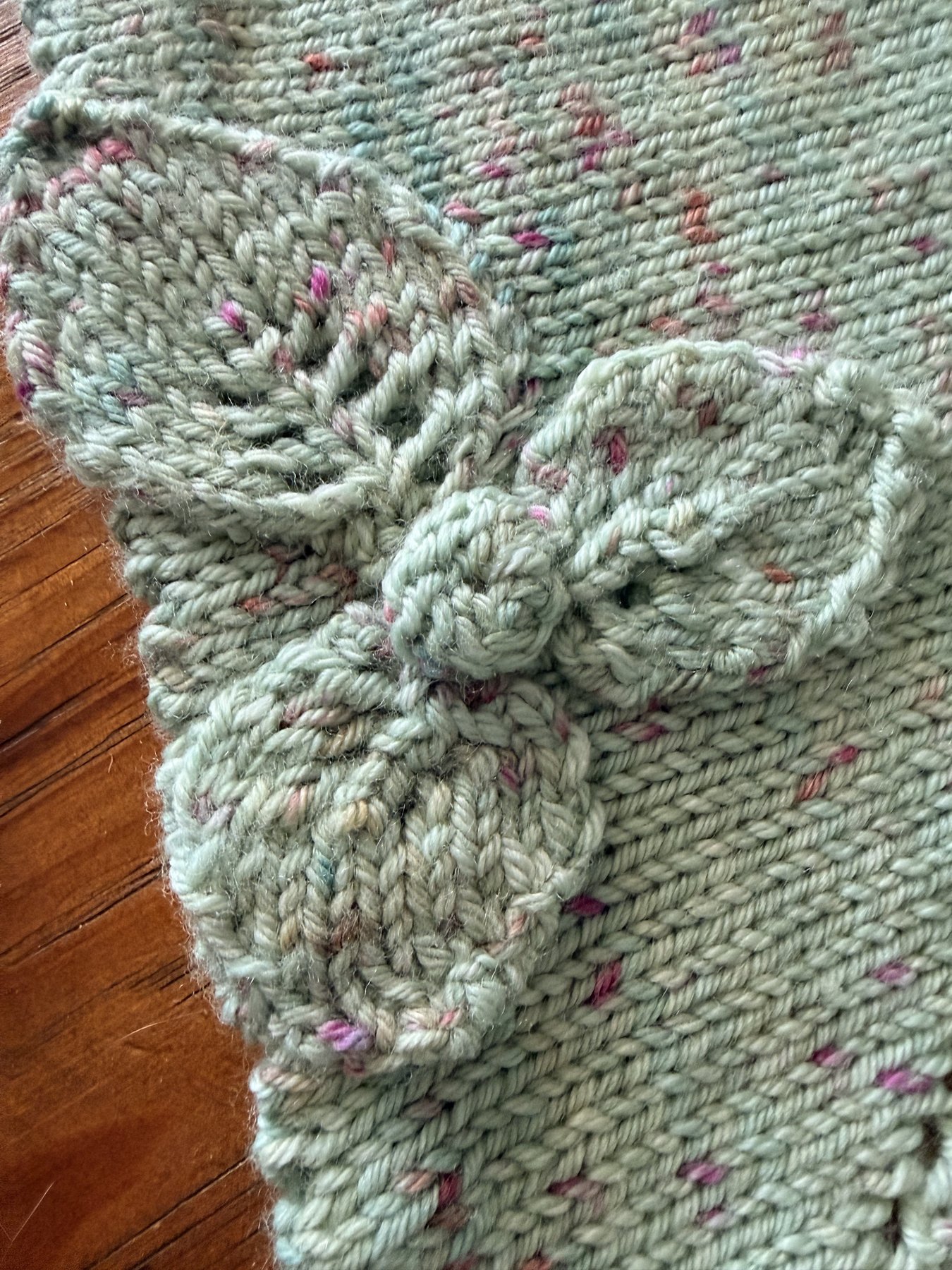 Macro detail of the knitted flower appliqué